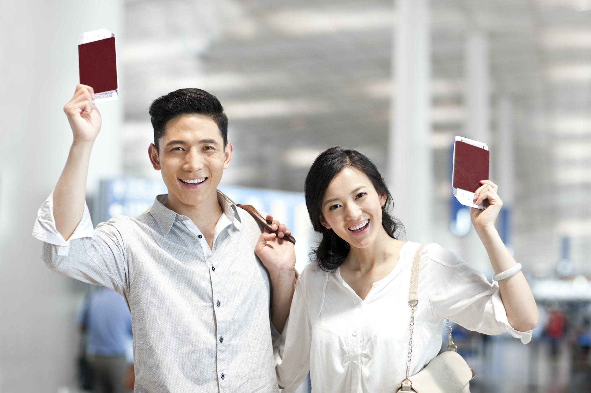 young-couple-at-the-airport-with-flight-tickets-and-passports.jpg